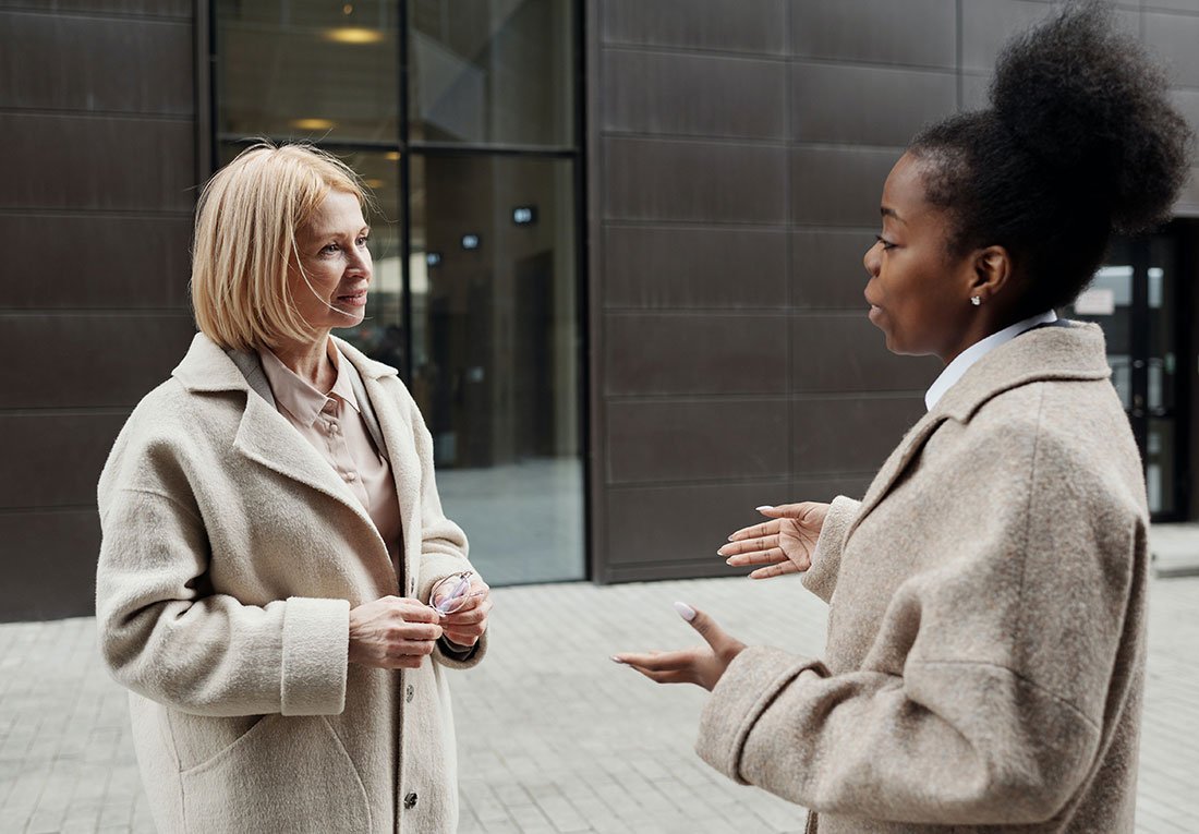 Two real estate investment consultants having a discussion outdoors.