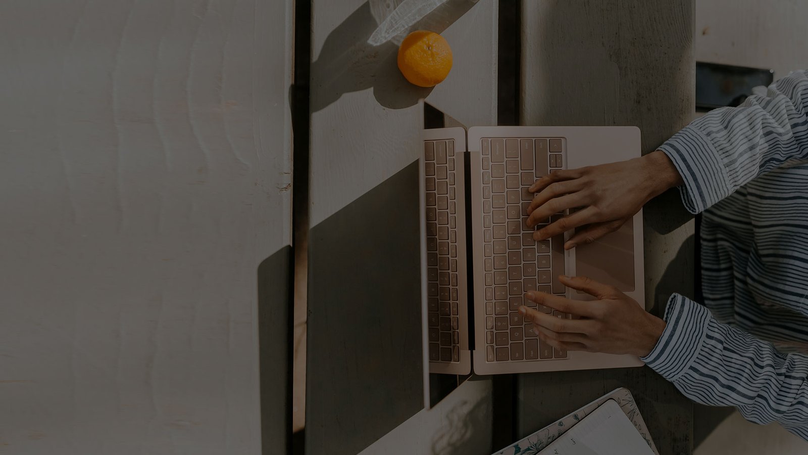 User accessing real estate investment portfolio remotely on a laptop.