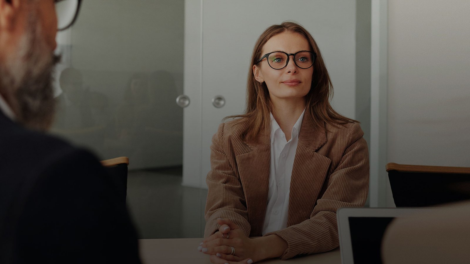 Investment consultant wearing a headset and reviewing documents, representing the first step in the client onboarding process.